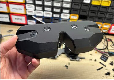 The Vector Gear shell held in one hand.